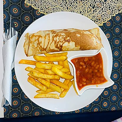 Coastal breakfast special: pancake with wors, hot relish, curried baked beans and fries