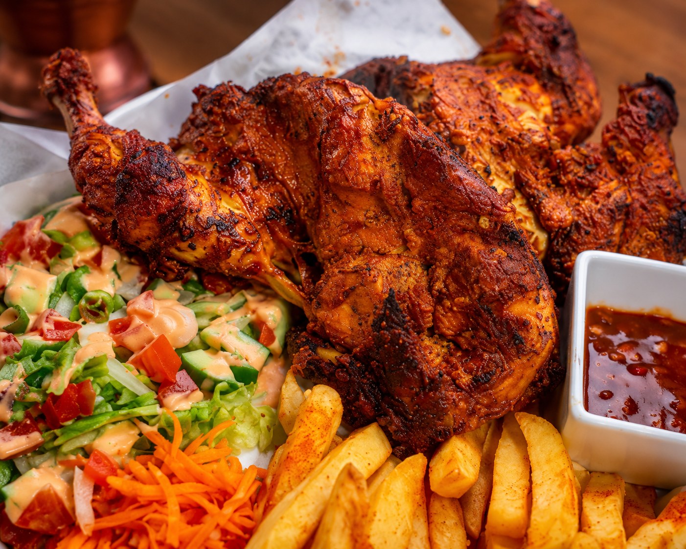 Whole Chicken Tikka Family Meal: flame-grilled chicken tikka served with rotis, chips and salad